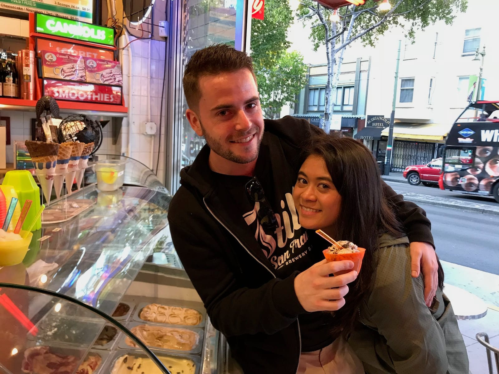 Sharing gelato at a shop counter