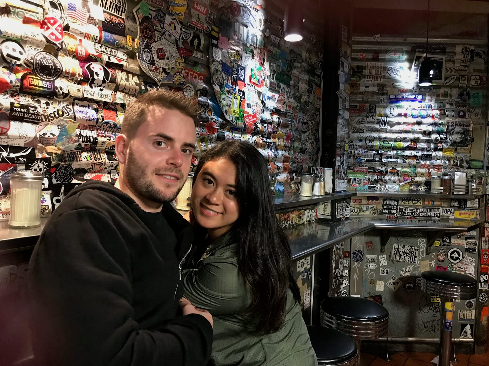 Hugging in a sticker-covered diner