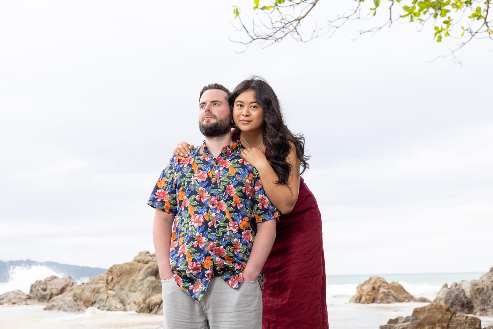 Standing together on the beach, arms around each other