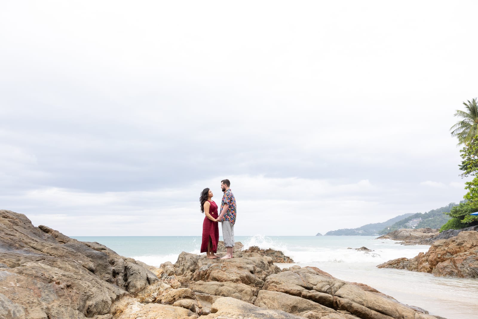 Standing on seaside rocks under a wide sky